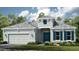 Charming one-story home features a two-car garage, well manicured lawn, blue door, and lovely architectural details at 5658 Nevis Ter, Kissimmee, FL 34758