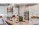 Gourmet kitchen features white cabinets, stainless steel appliances, granite countertops and a large center island at 5658 Nevis Ter, Kissimmee, FL 34758