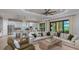 Open-concept living room with a kitchen view and sliding doors to an outdoor patio at 5658 Nevis Ter, Kissimmee, FL 34758