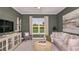 Cozy living room with shiplap accent wall, plush seating, and a bright window at 5658 Nevis Ter, Kissimmee, FL 34758