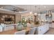 Open concept living space featuring a dining area, views of kitchen, a ceiling fan and wood accent wall at 5658 Nevis Ter, Kissimmee, FL 34758
