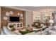 Comfortable living room with wood accent wall, white couch and chairs, and view of dining area at 5658 Nevis Ter, Kissimmee, FL 34758