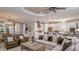 Spacious open-concept living room with modern decor, a large island, and ample seating at 5658 Nevis Ter, Kissimmee, FL 34758