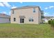 Backyard featuring a freshly sodded lawn with privacy fence and sliding glass door access at 5896 Galloping Dr, Apopka, FL 32712