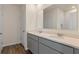 Bathroom featuring double sinks, gray cabinets, hard surface countertops, and wood look flooring at 5896 Galloping Dr, Apopka, FL 32712