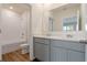 Bright bathroom featuring a double sink vanity with gray cabinets and a shower over tub at 5896 Galloping Dr, Apopka, FL 32712