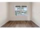Bedroom showing durable wood-look flooring, window view, and neutral paint at 5896 Galloping Dr, Apopka, FL 32712