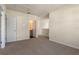 Spacious bedroom with neutral walls, plush carpet, and doorways leading to a bathroom and other rooms at 5896 Galloping Dr, Apopka, FL 32712