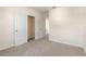 Cozy bedroom with plush carpet, neutral walls, and a glimpse into an open closet and doorway at 5896 Galloping Dr, Apopka, FL 32712