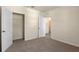 Bright bedroom with plush carpet, neutral walls, and access to an open closet and a hallway at 5896 Galloping Dr, Apopka, FL 32712