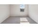 Bright bedroom with plush carpet, neutral walls, and a window offering a view of the sky at 5896 Galloping Dr, Apopka, FL 32712