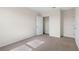 Neutral bedroom featuring plush carpet, an open closet, and a closed door in a freshly painted space at 5896 Galloping Dr, Apopka, FL 32712