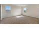 Spacious bedroom featuring carpet, two windows for natural light, and electrical outlets at 5896 Galloping Dr, Apopka, FL 32712