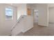 Upstairs hallway landing leading to carpeted bedrooms with natural light from a window at 5896 Galloping Dr, Apopka, FL 32712