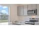 Bright kitchen features stainless appliances, gray cabinets, and hard surface countertops at 5896 Galloping Dr, Apopka, FL 32712