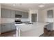 Kitchen showcasing stainless appliances, grey cabinets, a pantry, an island, and hard surface countertops at 5896 Galloping Dr, Apopka, FL 32712
