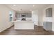 Modern kitchen with gray cabinets, quartz countertops, stainless steel appliances, and wood-look floors at 5896 Galloping Dr, Apopka, FL 32712