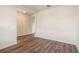 Living space featuring durable wood-look flooring and neutral walls, showcasing simplicity at 5896 Galloping Dr, Apopka, FL 32712