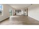 Open-concept living room with wood-look floors flowing into a modern kitchen with gray cabinets at 5896 Galloping Dr, Apopka, FL 32712