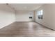 Spacious, sunlit living room with wood-look floors and large windows at 5896 Galloping Dr, Apopka, FL 32712