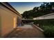 Private backyard patio area at dusk featuring brick pavers, gravel landscaping, and a serene atmosphere at 5973 Chesapeake Park # 58, Orlando, FL 32819