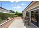 Backyard patio with brick pavers, gravel landscaping, and a neatly trimmed hedge providing a relaxing outdoor retreat at 5973 Chesapeake Park # 58, Orlando, FL 32819
