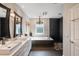 Elegant bathroom featuring double sinks, a soaking tub, a walk-in shower, and updated finishes at 5973 Chesapeake Park # 58, Orlando, FL 32819