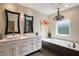 Modern bathroom with double sinks, quartz countertops, soaking tub, and stylish fixtures at 5973 Chesapeake Park # 58, Orlando, FL 32819