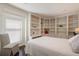 Cozy bedroom with built-in shelving, a reading nook, and natural light from a large window at 5973 Chesapeake Park # 58, Orlando, FL 32819