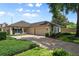 Well-maintained single-story home with a two-car garage, beautiful landscaping, and an inviting entrance at 5973 Chesapeake Park # 58, Orlando, FL 32819