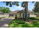 Inviting single-story home featuring mature landscaping and a private driveway leading to the entrance at 5973 Chesapeake Park # 58, Orlando, FL 32819