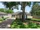 Charming single-story home with lush landscaping, mature tree and long driveway in the front yard at 5973 Chesapeake Park # 58, Orlando, FL 32819