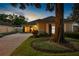 Charming single-story home with lush landscaping, mature tree and long driveway at twilight at 5973 Chesapeake Park # 58, Orlando, FL 32819