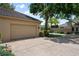 Attached garage with spacious driveway lined with lush landscaping, shrubs and trees at 5973 Chesapeake Park # 58, Orlando, FL 32819