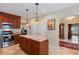 Spacious kitchen with wood cabinets, granite countertops, stainless steel appliances, and a center island at 5973 Chesapeake Park # 58, Orlando, FL 32819