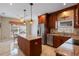 Efficient kitchen with stainless steel appliances, granite countertops, and an adjacent breakfast nook at 5973 Chesapeake Park # 58, Orlando, FL 32819