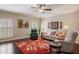 Inviting living room with a red rug, comfortable seating, and natural light from shuttered windows enhancing the home at 5973 Chesapeake Park # 58, Orlando, FL 32819