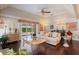 Inviting living room with hardwood floors, a ceiling fan, and access to the outdoor patio at 5973 Chesapeake Park # 58, Orlando, FL 32819