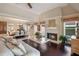 Cozy living room with a fireplace, hardwood floors, and seamless transition into dining space at 5973 Chesapeake Park # 58, Orlando, FL 32819