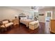 Comfortable main bedroom featuring hardwood floors, a ceiling fan, and an en suite bathroom at 5973 Chesapeake Park # 58, Orlando, FL 32819