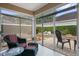 Inviting sunroom featuring tile flooring, glass sliding doors, and comfortable seating with views of the landscaped patio area at 5973 Chesapeake Park # 58, Orlando, FL 32819