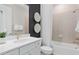 White bathroom features a bathtub shower combo and designer mirror decor at 6035 Blue View Way, St Cloud, FL 34771