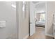 Elegant bathroom features a walk-in shower with hexagon tiles and access to the main bedroom at 6035 Blue View Way, St Cloud, FL 34771