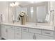 Stylish bathroom boasts a double vanity, quartz countertop, undermount sinks, and updated lighting at 6035 Blue View Way, St Cloud, FL 34771