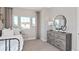 Well-lit bedroom featuring modern decor, large windows, and neutral color palette at 6035 Blue View Way, St Cloud, FL 34771
