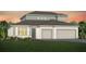 Charming two-story home featuring an attached two car garage, neutral color palette, and professionally landscaped lawn at 6035 Blue View Way, St Cloud, FL 34771