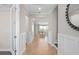 View of the foyer featuring hardwood flooring, neutral walls, and open access to the living room at 6035 Blue View Way, St Cloud, FL 34771