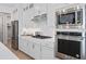 Well-equipped kitchen boasting stainless steel appliances and sleek white cabinetry at 6035 Blue View Way, St Cloud, FL 34771