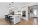Eat-in kitchen with pendant lighting, stainless steel appliances, large island and hardwood floors at 6035 Blue View Way, St Cloud, FL 34771