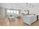 Open concept living room, dining room, and kitchen featuring hardwood floors and natural light at 6035 Blue View Way, St Cloud, FL 34771